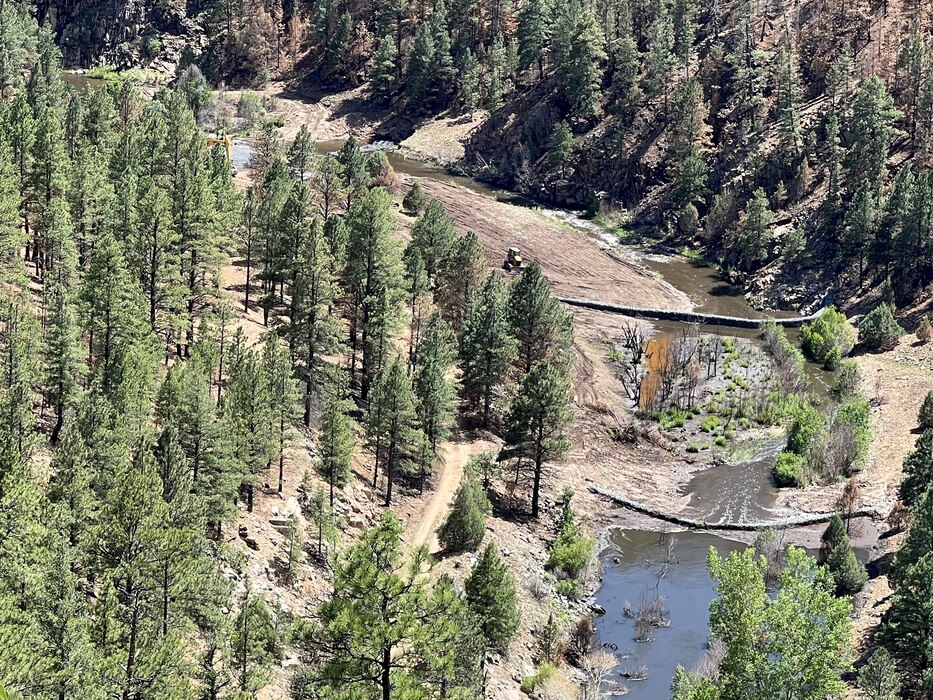 GALLINAS, N.M. – A contractor works on the newly constructed gabions in the Gallinas River, two miles east of Gallinas, N.M., upstream from the Las Vegas, N.M., water supply intake structures, June 29, 2022. This photo shows work that was completed within two weeks after the Hermits Peak/Calf Canyon Fire burned through the area. Photo by Chris Carroll.