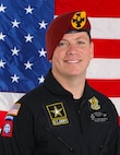 man standing in front of two flags.