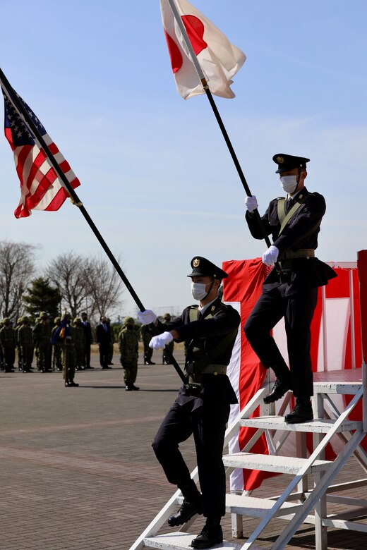 Two Japan Ground Self-Defense Force members march the Japanese and American flags onto the parade deck March 4 during a ceremony marking the JGSDF’s 10-year anniversary co-located on the Camp Zama with the U.S. Army in Japan.