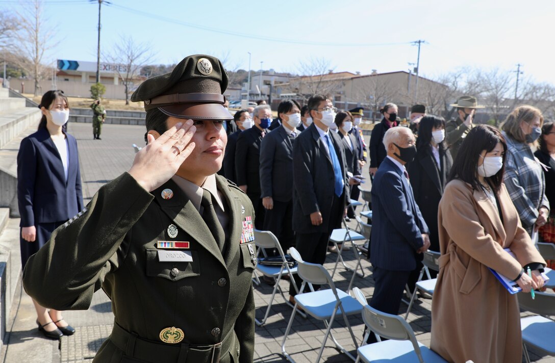 Master Sgt. Raquel Orozco, I Corps (Forward) sergeant major, salutes the arrival of the Japanese and American flags and the playing of both countries’ anthems March 4 during a ceremony marking the JGSDF’s 10-year anniversary co-located on the Camp Zama with the U.S. Army in Japan.