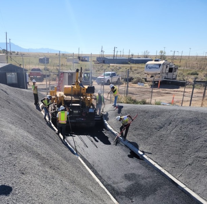KIRTLAND AIR FORCE BASE, N.M. – Workers and machinery lay asphalt from the Cobalt 60 Test Facility up towards the parking area, Oct. 31, 2022. Photo by Greg Callister.