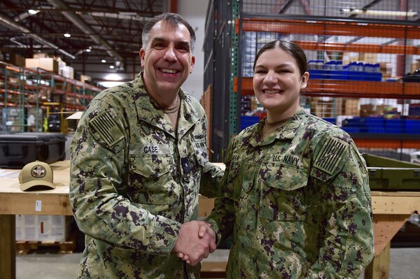 Rear Adm. Matthew Case, Naval Medical Forces Atlantic (NMFL) commander and director, Tidewater Market, presents a coin to Logistics Specialist Seaman Jasmine Coleman, assigned to Navy Medicine Readiness and Training Command (NMRTC) Bethesda.