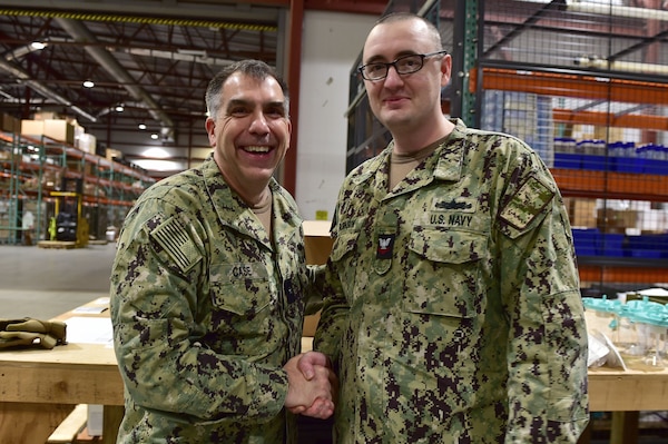 Rear Adm. Matthew Case, Naval Medical Forces Atlantic (NMFL) commander and director, Tidewater Market, presents a coin to Logistics Specialist 2nd Class Charles Robinson, assigned to Navy Medicine Readiness and Training Command (NMRTC) Portsmouth.