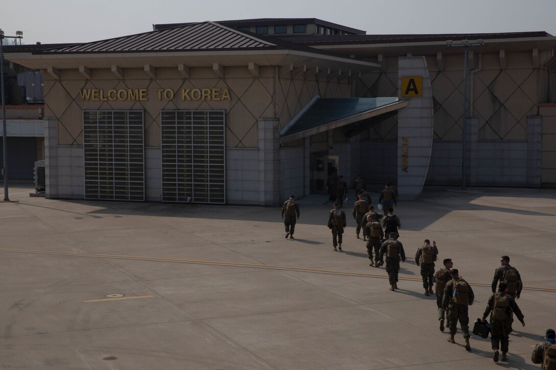 U.S. Marines with Headquarters Battalion, 1st Marine Division, currently attached to III Marine Expeditionary Force, enter the arrival terminal at Osan Air Base, Geyonggi, Korea, to begin exercise Freedom Shield 23, March 5, 2023. The 1st MARDIV attached to III MEF to serve as the ground combat element for the Combined Marine Component Command, Combined Forces Command, during FS 23. Freedom Shield is a defense-oriented exercise designed to strengthen the ROK-U.S. Alliance, enhance our combined defense posture, and strengthen security and stability on the Korean peninsula. (U.S. Marine Corps photo by Sgt. Frank Webb)