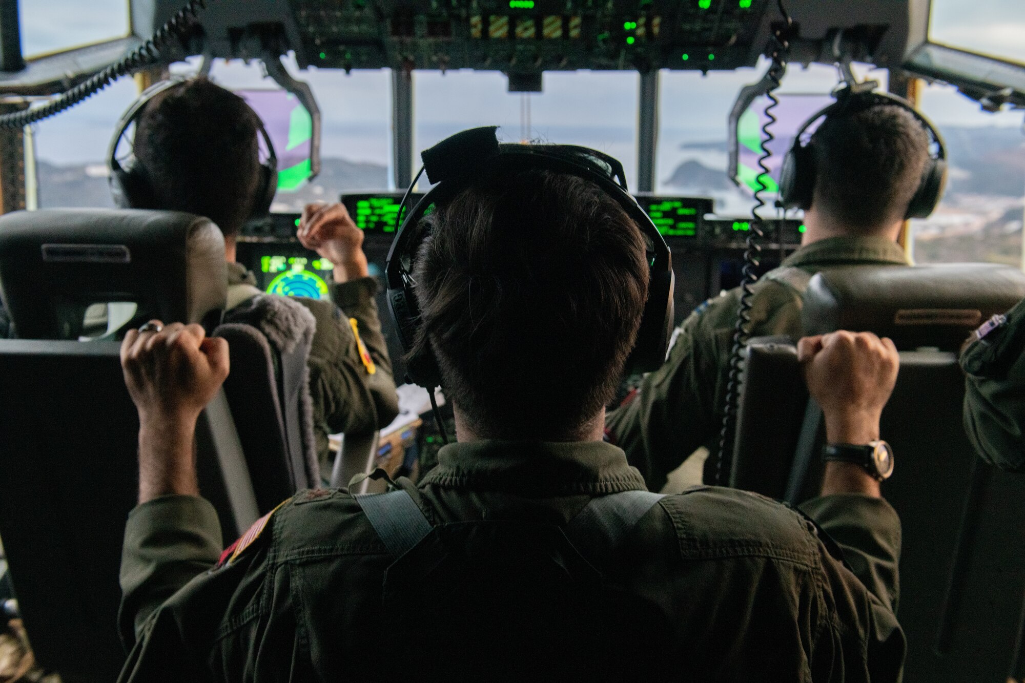 Pilots fly a C-130J