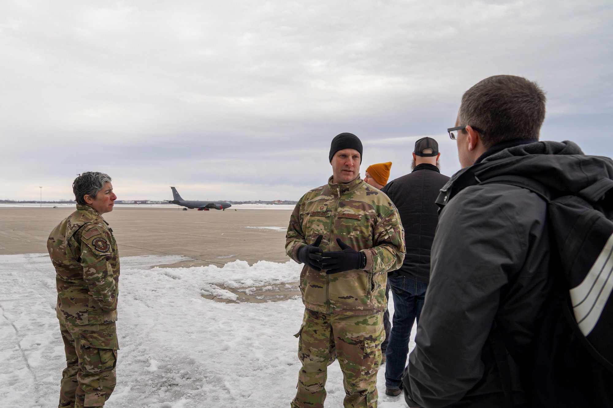 Airmen speaking to civilians on flightline.