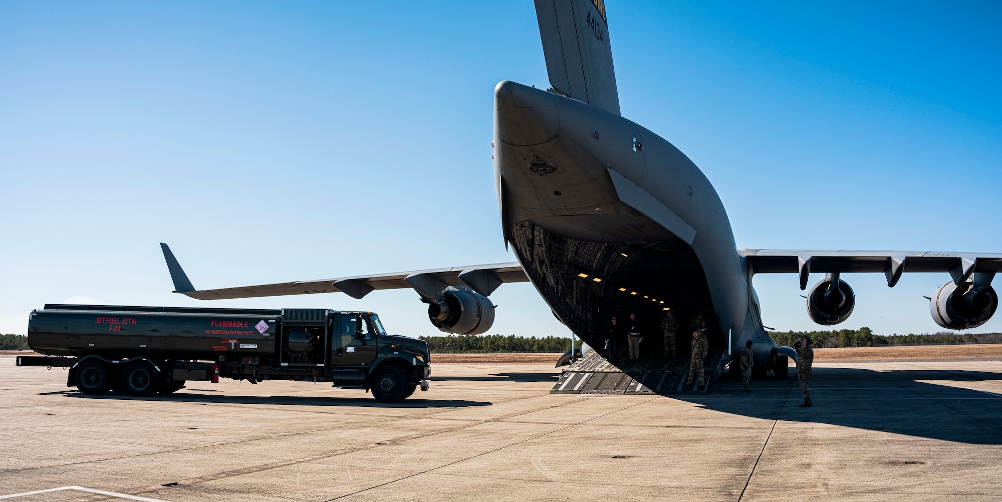 Airmen assigned to the 305th Air Mobility Wing and 87th Air Base Wing position an R-11 fuel truck to perform a wet-wing defuel with a C-17 Globemaster at Joint Base McGuire-Dix Lakehurst, N.J., Mar. 9. 2023.