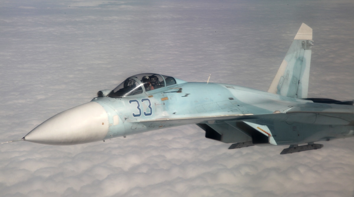 A jet flies above thick clouds.
