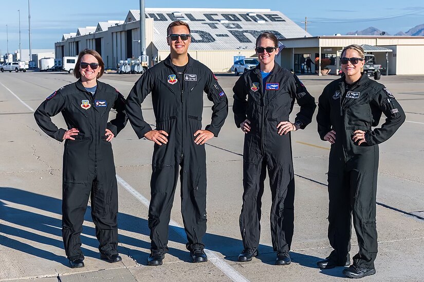 Four airmen pose for a photo.