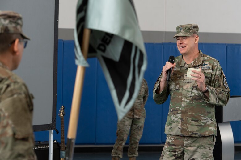 Man in military uniform speaking into microphone