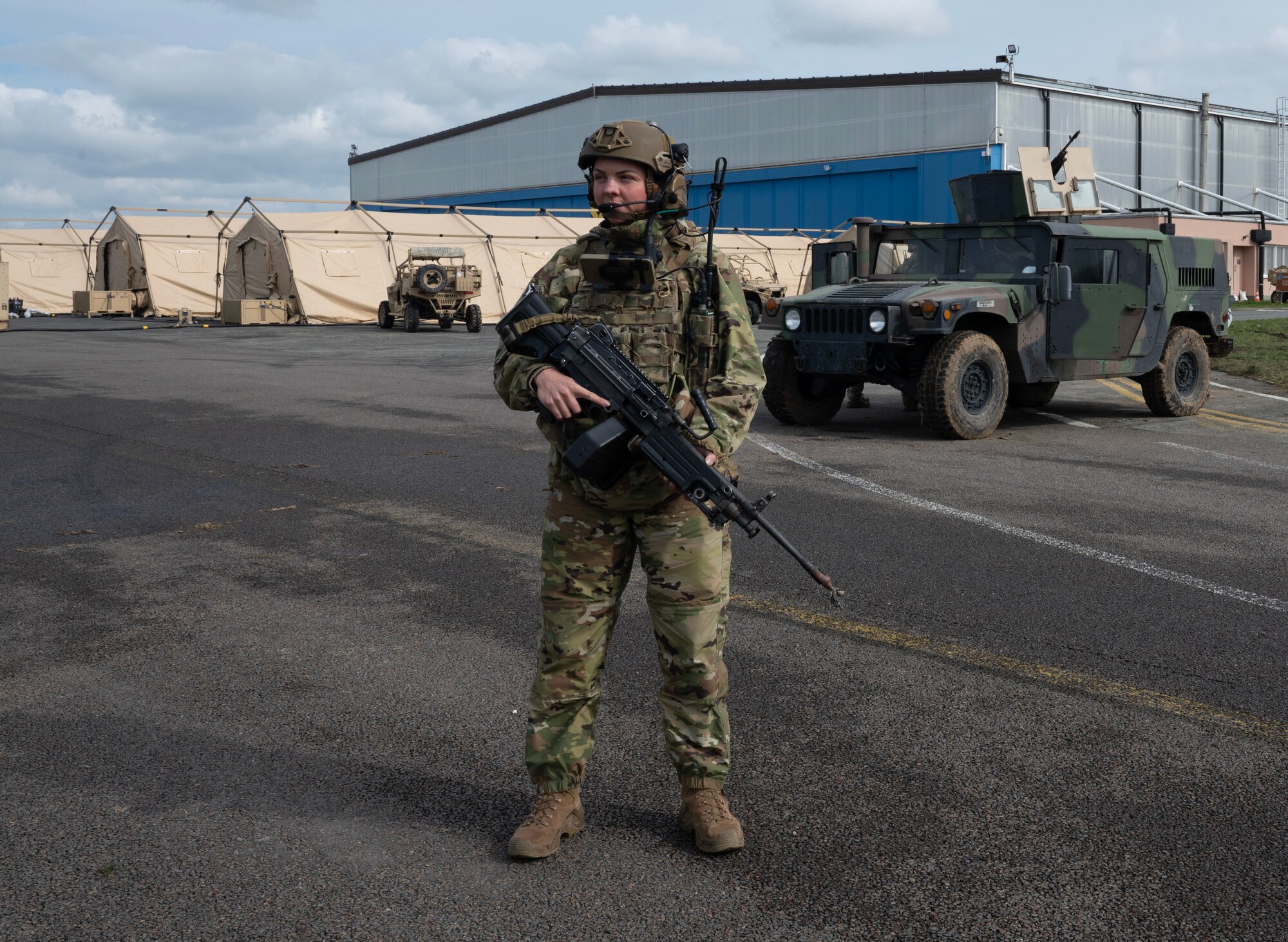 U.S. Air Force Staff Sgt. Jacklyn Edgmond, 435th Security Forces Squadron contingency response team leader, carries an M-249 light machine gun for force protection as part of Exercise Agile Bison at Chièvres Air Base, Belgium, March 11, 2023.