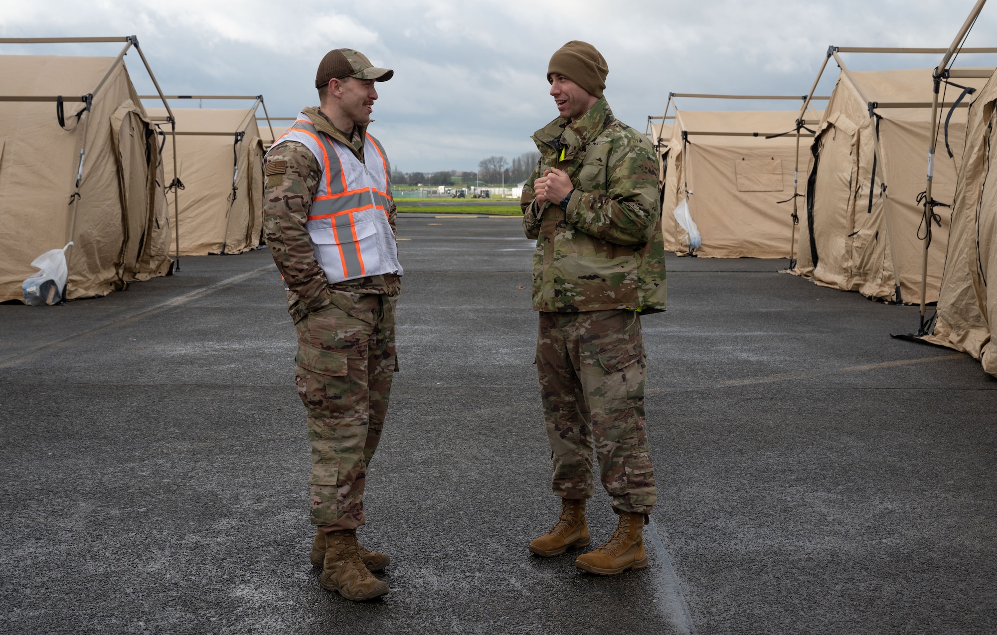 U.S. Air Force Maj. Andrew Weubold, right, 435th Contingency Response Group, contingency response element commander, discusses the upcoming redeployment to Ramstein Air Base, Germany, with Master Sgt. Blake Fagan, 435th CRG operations superintendent and white cell evaluator, during Exercise Agile Bison at Chièvres Air Base, Belgium, March 13, 2023.