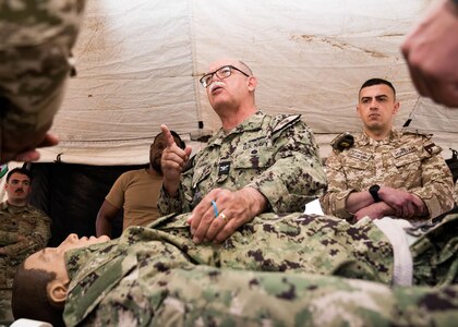 230312-A-NR779-1059 AQABA, Jordan (March 12, 2023) Capt. Miguel Cubano, assigned to U.S. Naval Forces Central Command, speaks to multinational partners while they conduct medical training in Aqaba, Jordan, March 12, 2023, during International Maritime Exercise 2023. IMX/CE 2023 is the largest multinational training event in the Middle East, involving 7,000 personnel from more than 50 nations and international organizations committed to preserving the rules-based international order and strengthening regional maritime security cooperation. (U.S. Army photo by Spc. Aaron Troutman)
