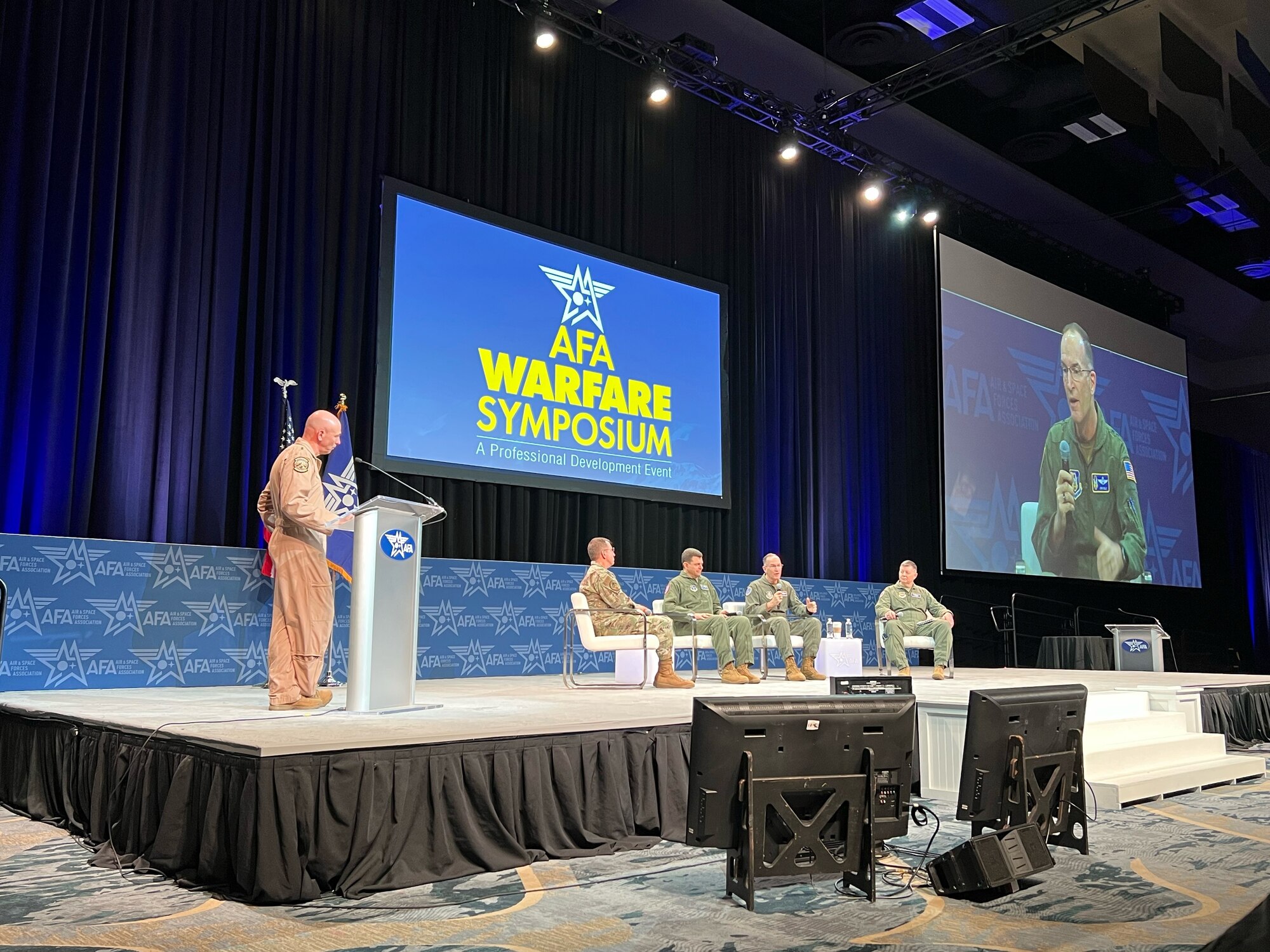 Photo of the individuals in seats speaking at the panel.