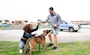 Naples Security Officer Lt. Cmdr. Alex Lamis congratulates dog handler Master-at-Arms 2nd Class Kashira Collins, left, and Debbie, a military working dog, for completing the Morale, Welfare, and Recreation's K9 5K Run onboard NSA Naples in Gricignano di Aversa, Italy, March 11, 2023.