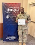 Sgt. Osse Jeanpierre shows off his U.S. citizenship certificate following his swearing in as a U.S. citizen Dec. 15, 2022, in Tukwila, Wash. The Washington National Guard member left Haiti as a 9-year-old.