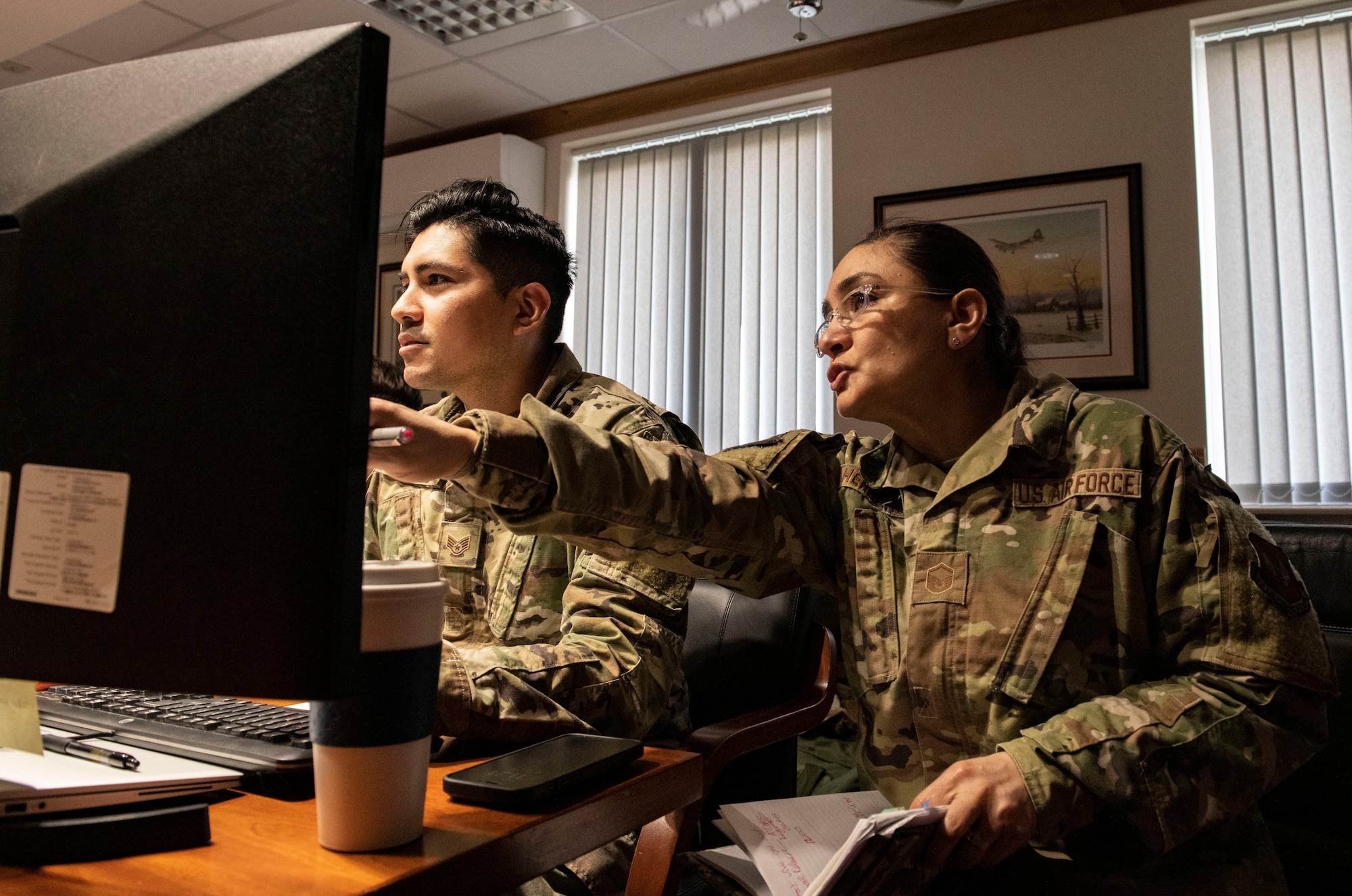 Staff Sgt. Rafael Daniel, 501st Combat Support Wing Crisis Action Team admin, left, and Master Sgt. Yara Hernandez, 501st CSW executive services superintendent, work in the CAT at RAF Alconbury,