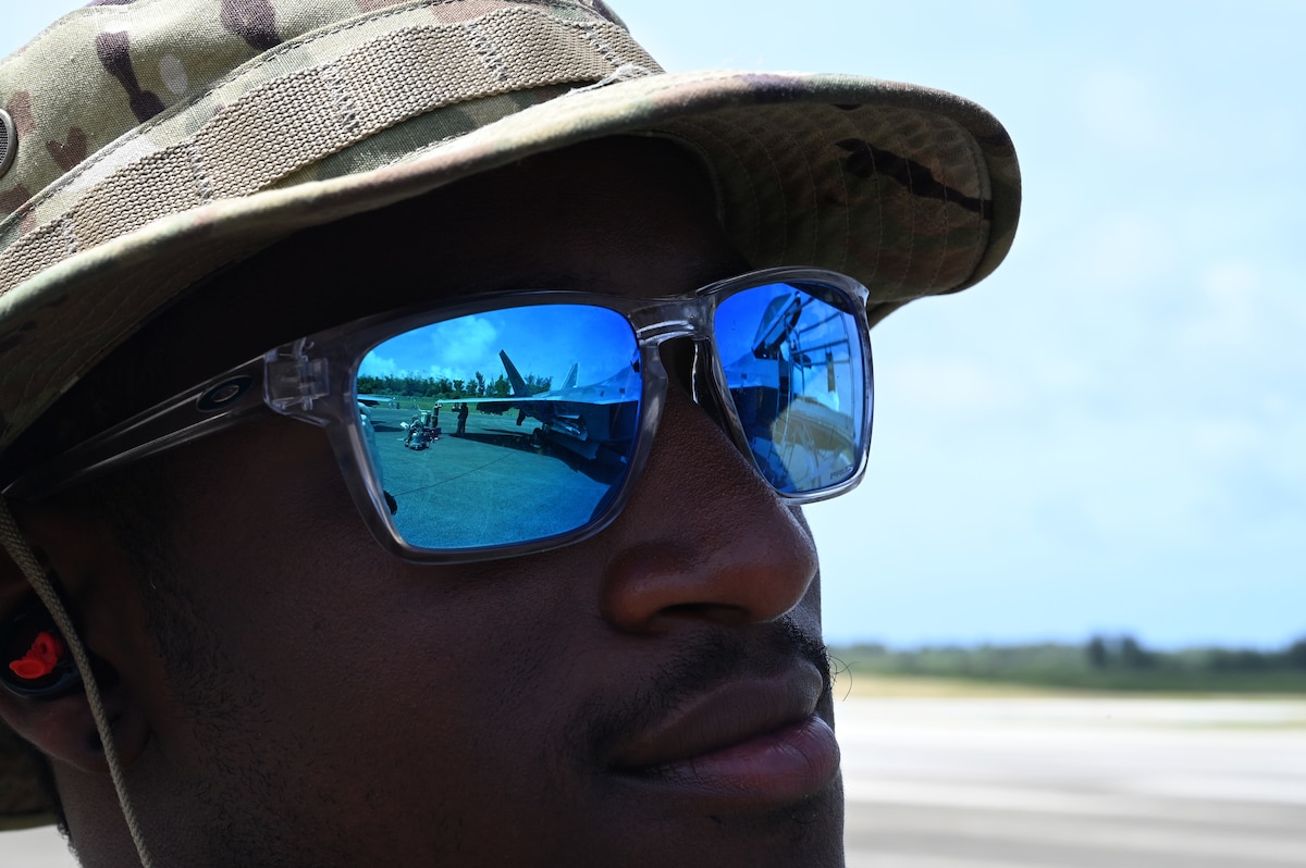An F-22 Raptor assigned to the 525th Expeditionary Fighter Squadron, Kadena Air Base, Japan, can be seen in the reflection of the sunglasses of Staff Sgt. Von Peoples, an F-22 dedicated crew chief assigned to the 525th Expeditionary Fighter Squadron, during Exercise Agile Reaper 23-1 at Tinian International Airport, Northern Mariana Islands, March 3, 2023. AR 23-1 is the 3rd AEW’s effort to exercise Agile Combat Employment, rehearse capabilities in an operationally relevant environment and to provide air dominance, global mobility and command and control in the Indo-Pacific region. (U.S. Air Force photo by Tech. Sgt. Hailey Staker)
