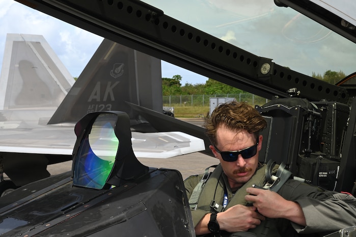 Romo, an F-22 Raptor pilot assigned to the 525th Expeditionary Fighter Squadron, Kadena Air Base, Japan, fastens his seatbelt prior to a training sortie during Exercise Agile Reaper 23-1 at Tinian International Airport, Northern Mariana Islands, March 3, 2023. During the exercise, C-17s and F-22 Raptors assigned to the 525th Expeditionary Fighter Squadron will conduct training operations in the Mariana Islands Range Training Complex. The MIRC is a geographic area containing a complex of military training ranges, and includes land, sea, and airspace on and around the islands of Guam, Rota, Tinian, Saipan, and Farallon de Medinilla, as well as open ocean waters stretching north to Pagan and west to the middle of the Philippine Sea. (U.S. Air Force photo by Tech. Sgt. Hailey Staker)
