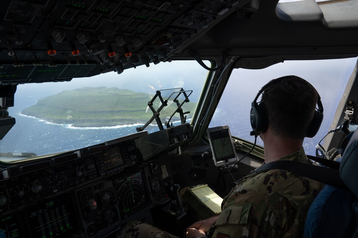 A U.S. Air Force pilot assigned to the 3rd Air Expeditionary Wing flys C-17 Globemaster III assigned to the 15th Wing, Joint Base Pearl-Hickam, Hawaii, over the Northern Mariana Islands during Exercise Agile Reaper 23-1, March 4, 2023. AR 23-1 supports the Air Force’s requirement for expeditionary skills necessary to operate outside of military installations; Airmen must have diverse skills that enable them to operate in a contested, degraded, and operationally limited environment. (U.S. Air Force photo by Airman 1st Class Julia Lebens)