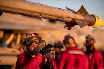 Aviation Ordnanceman 2nd Class Benjamin Tepe mounts a missile to an F/A-18F Super Hornet aboard USS Gerald R. Ford (CVN 78) in the Atlantic Ocean.