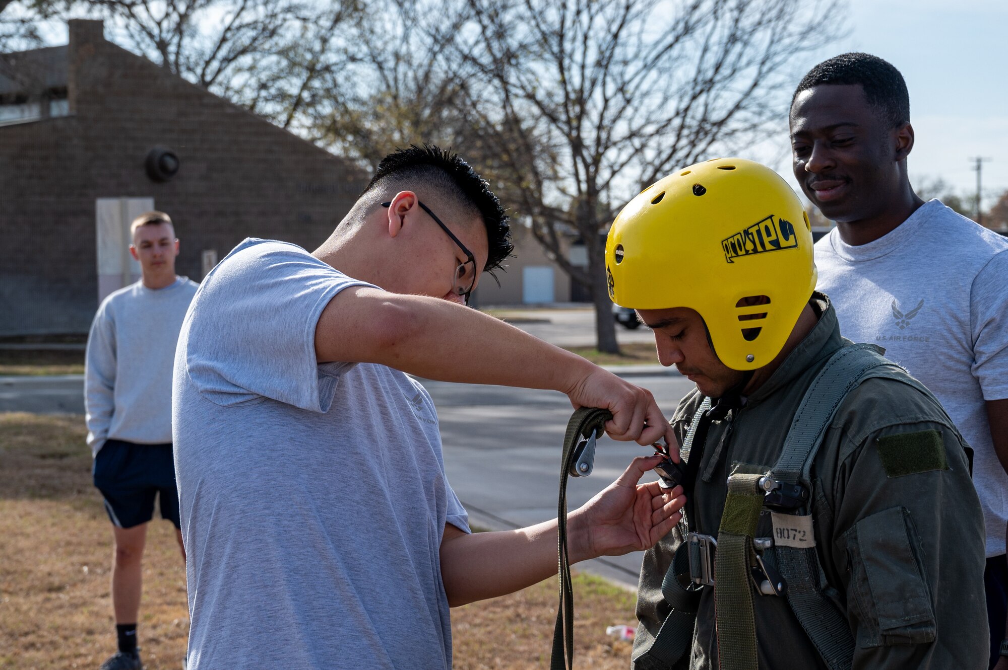 U.S. Air Force Airman from the aerospace physiology team at Laughlin Air Force Base, Texas, demonstrates the proper procedures in case of a parachute drag on Feb. 22, 2023. Aerospace physiologists and technicians train specifically on hypoxia, spatial disorientation, G-forces, day and night visual challenges, situational awareness, fatigue, sleep hygiene, nutrition and stress, safety, and crew resource management. (U.S. Air Force photo by Senior Airman David Phaff)