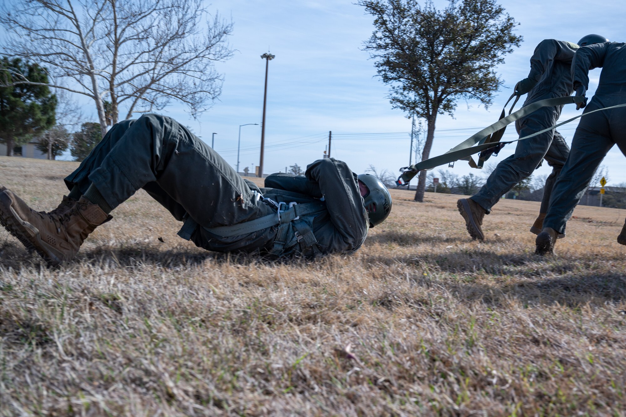 U.S. Air Force student pilots at Laughlin Air Force Base, Texas, practice the proper procedures in case of parachute drag on Feb. 22, 2023. All students visit the aerospace physiology team to train specifically on hypoxia, spatial disorientation, G-forces, day and night visual challenges, situational awareness, fatigue, sleep hygiene, nutrition and stress, safety, and crew resource management. (U.S. Air Force photo by Senior Airman David Phaff)