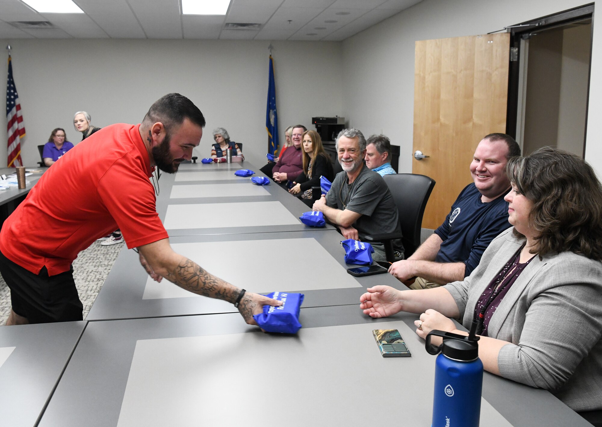 Man passing out overdose response kits to men and women