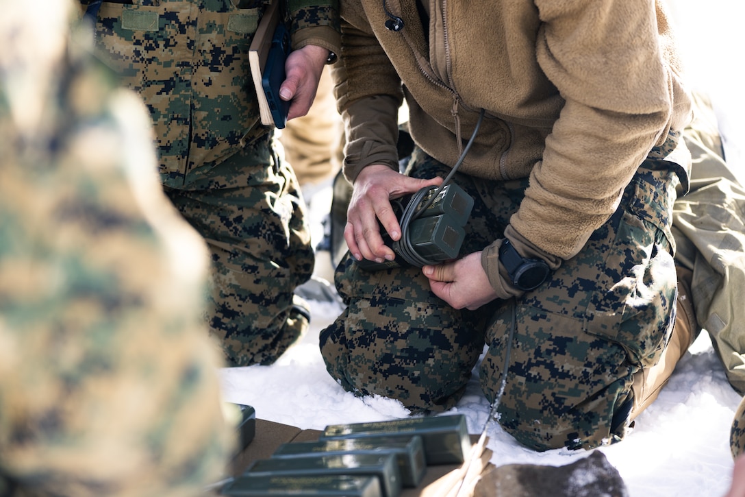 A U.S. Marine attending the Winter Mountain Engineer Course, wraps detonation cord around TNT while preparing an explosive at Marine Corps Mountain Warfare Training Center (MCMWTC), Bridgeport, California, Feb. 7, 2023. As part of the Winter Mountain Engineer Course, students learned how to use demolition to create holes in iced over lakes and trigger avalanches. (U.S. Marine Corps photo by Cpl. Andrew Bray)