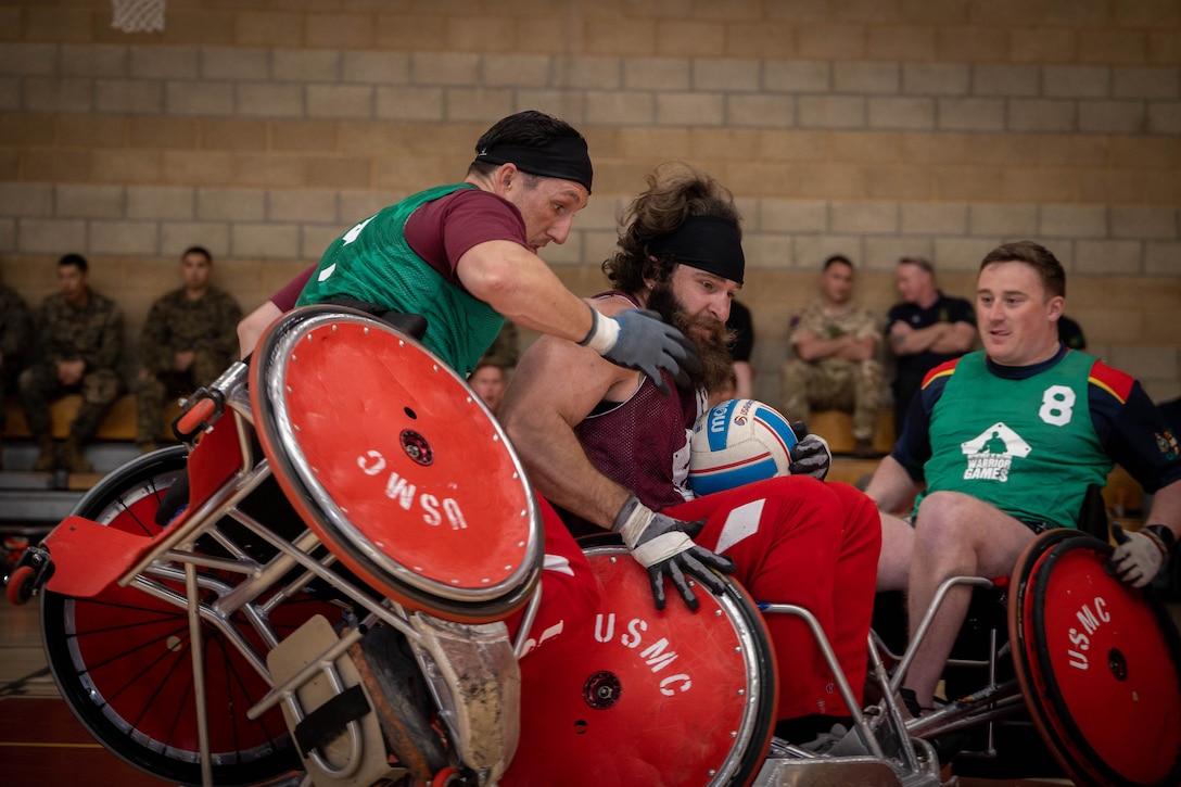 Wheelchair rugby players collide during competition.