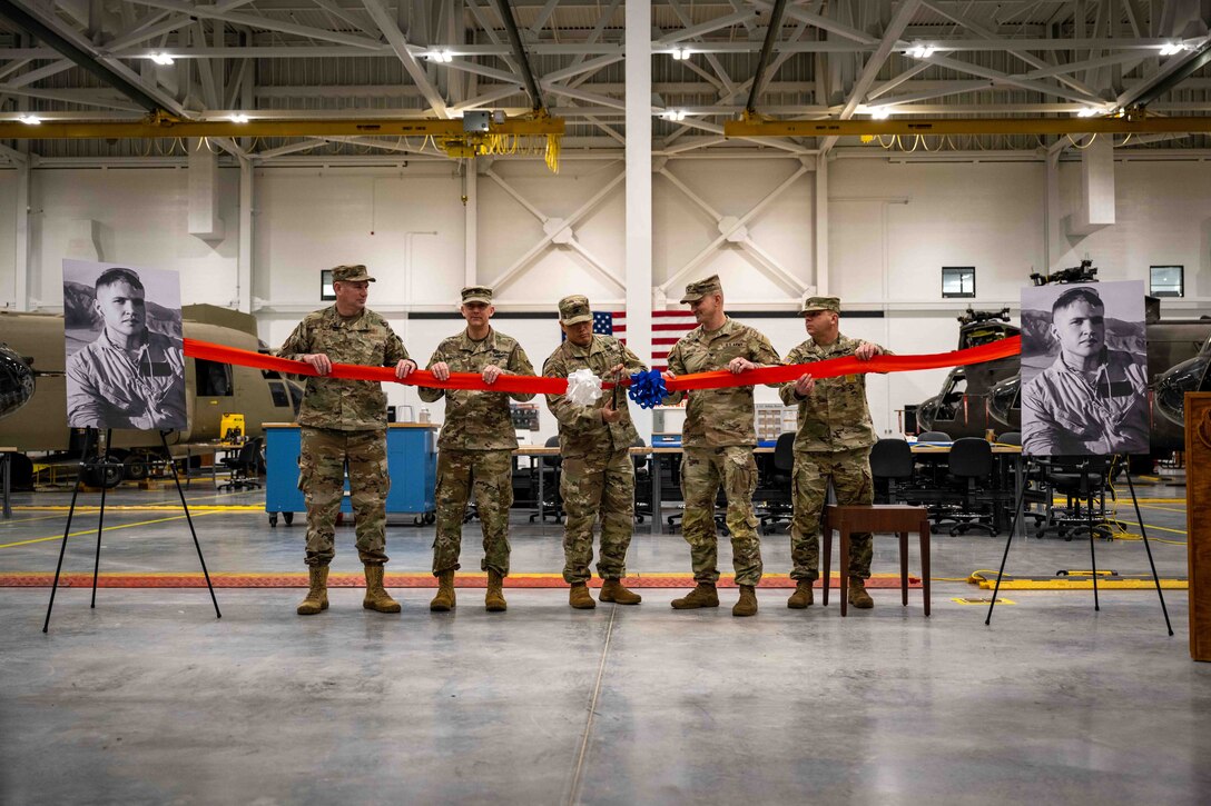 U.S. military leaders participate in a ribbon cutting ceremony.