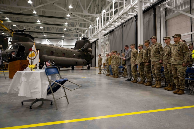 U.S. service members stand at attention during a ceremony.