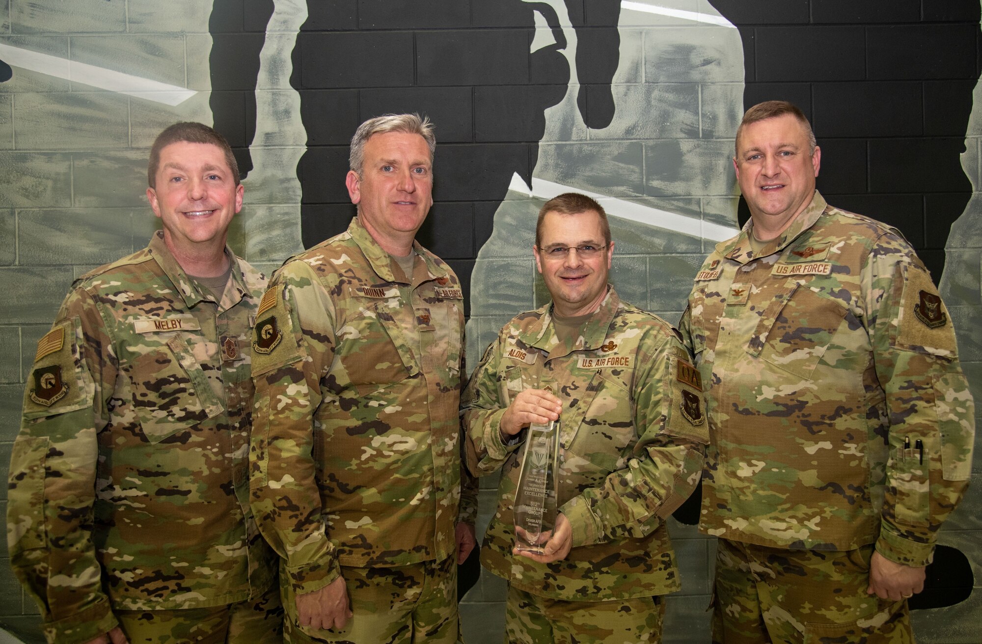 Leadership poses with trophy