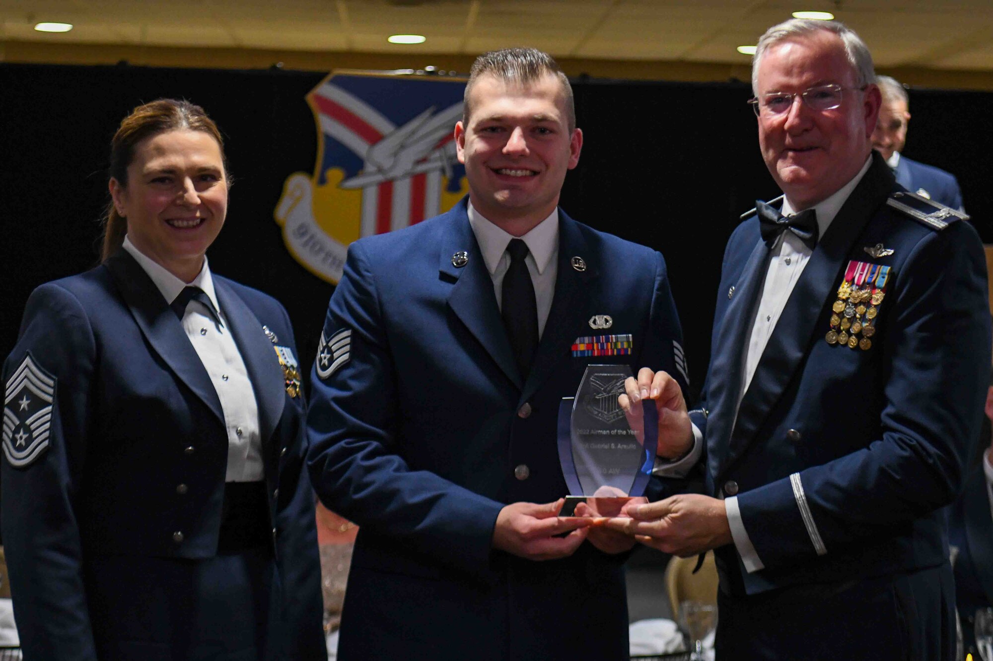 Staff Sgt. Gabriel Arsulic (center), the development and training flight leader assigned to the 910th Airlift Wing, receives the 2022 Airman of the Year award from 910th AW Commander Col. Jeff Van Dootingh (right) and 910th AW Command Chief Master Sgt. Jennifer McKendree (left), during the unit’s annual awards banquet, March 4, 2023, at Youngstown Air Reserve Station, Ohio.
