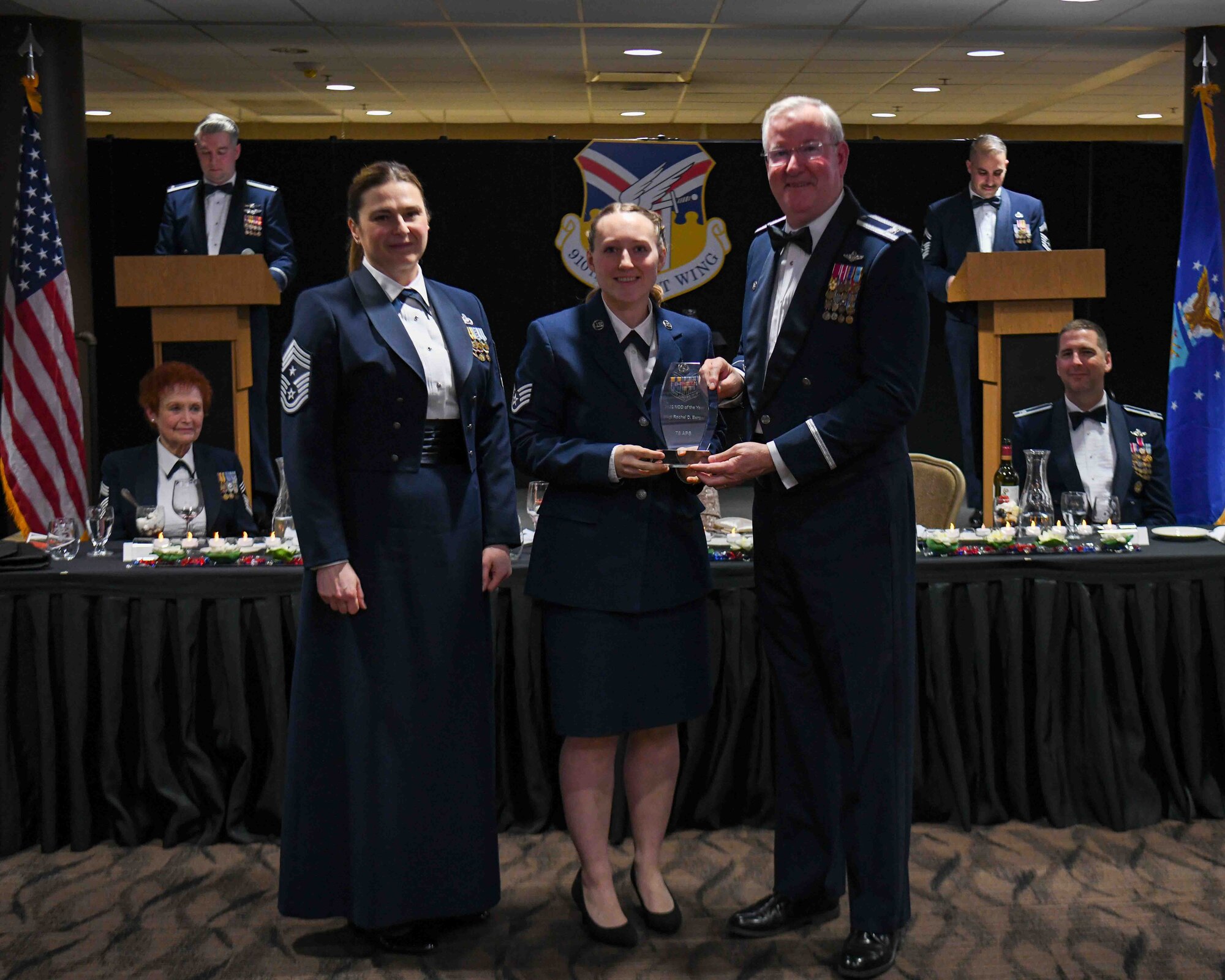 Staff Sgt. Rachel Berger (center), a special handling representative with the 76th Aerial Port Squadron, receives the Non-Commissioned Officer of the Year award from 910th Airlift Wing Commander Col. Jeff Van Dootingh (right) and 910th AW Command Chief Master Sgt. Jennifer McKendree (left), during the unit’s annual awards banquet, March 4, 2023, at Youngstown Air Reserve Station, Ohio.