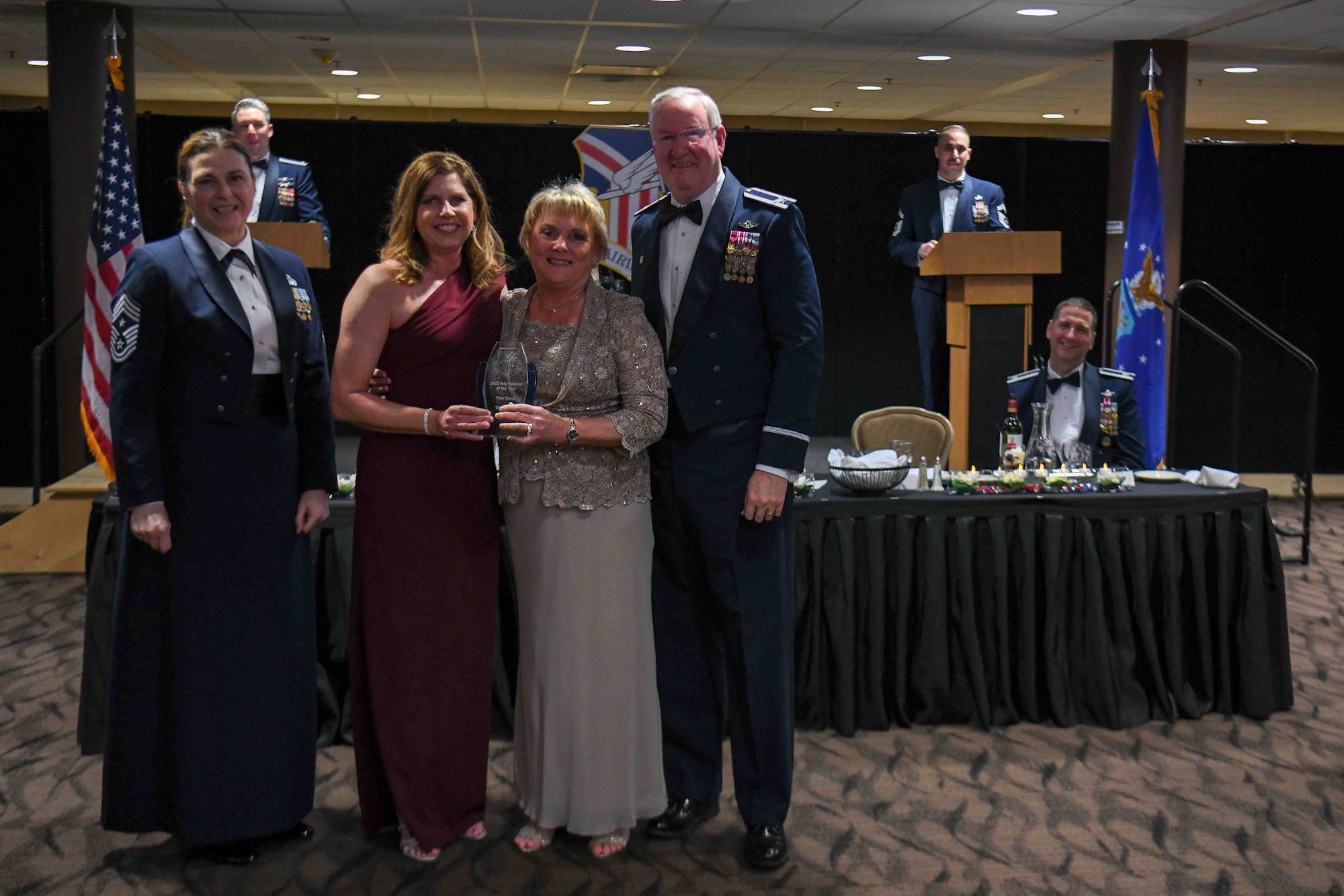 Tina Bond, a Key Spouse for the 910th Maintenance Squadron (center left), receives the 2022 Key Spouse of the Year award from 910th Airlift Wing Commander Col. Jeff Van Dootingh (right), his wife and 910th AW Key Spouse, Diana Van Dootingh (center right), and 910th AW Command Chief Master Sgt. Jennifer McKendree (left), during the unit’s annual awards banquet, March 4, 2023, at Youngstown Air Reserve Station, Ohio.