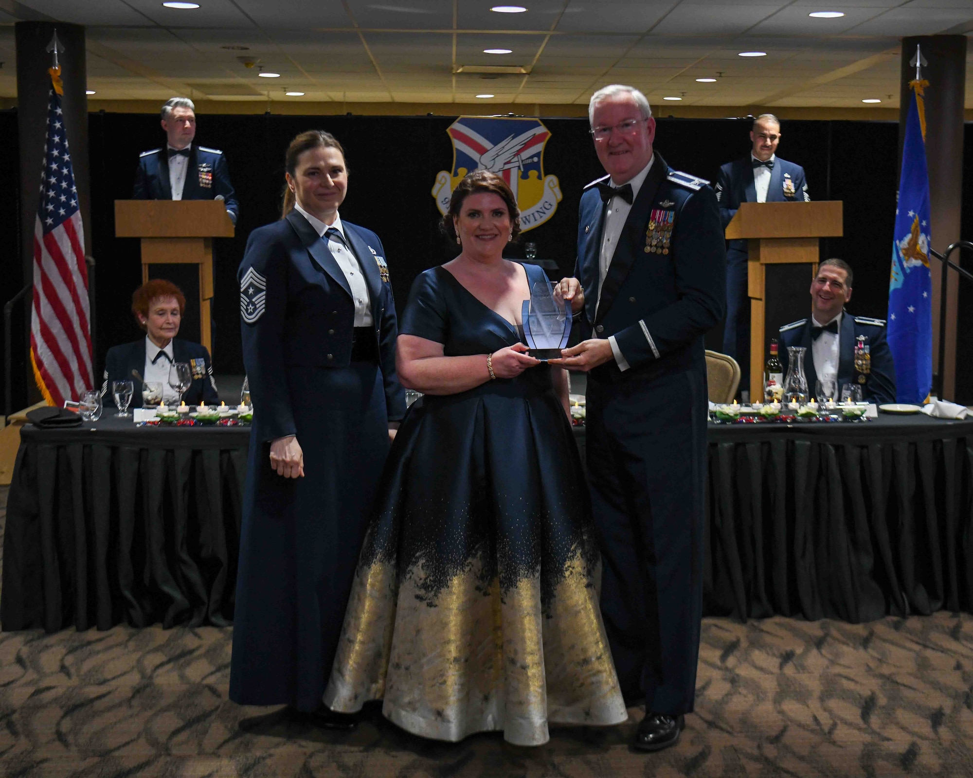 Shelly Trimble, the sexual assault response coordinator with the 910th Airlift Wing, receives the 2022 Senior Civilian of the Year award from 910th Airlift Wing Commander Col. Jeff Van Dootingh (right) and 910th AW Command Chief Master Sgt. Jennifer McKendree (left), during the unit’s annual awards banquet, March 4, 2023, at Youngstown Air Reserve Station, Ohio.