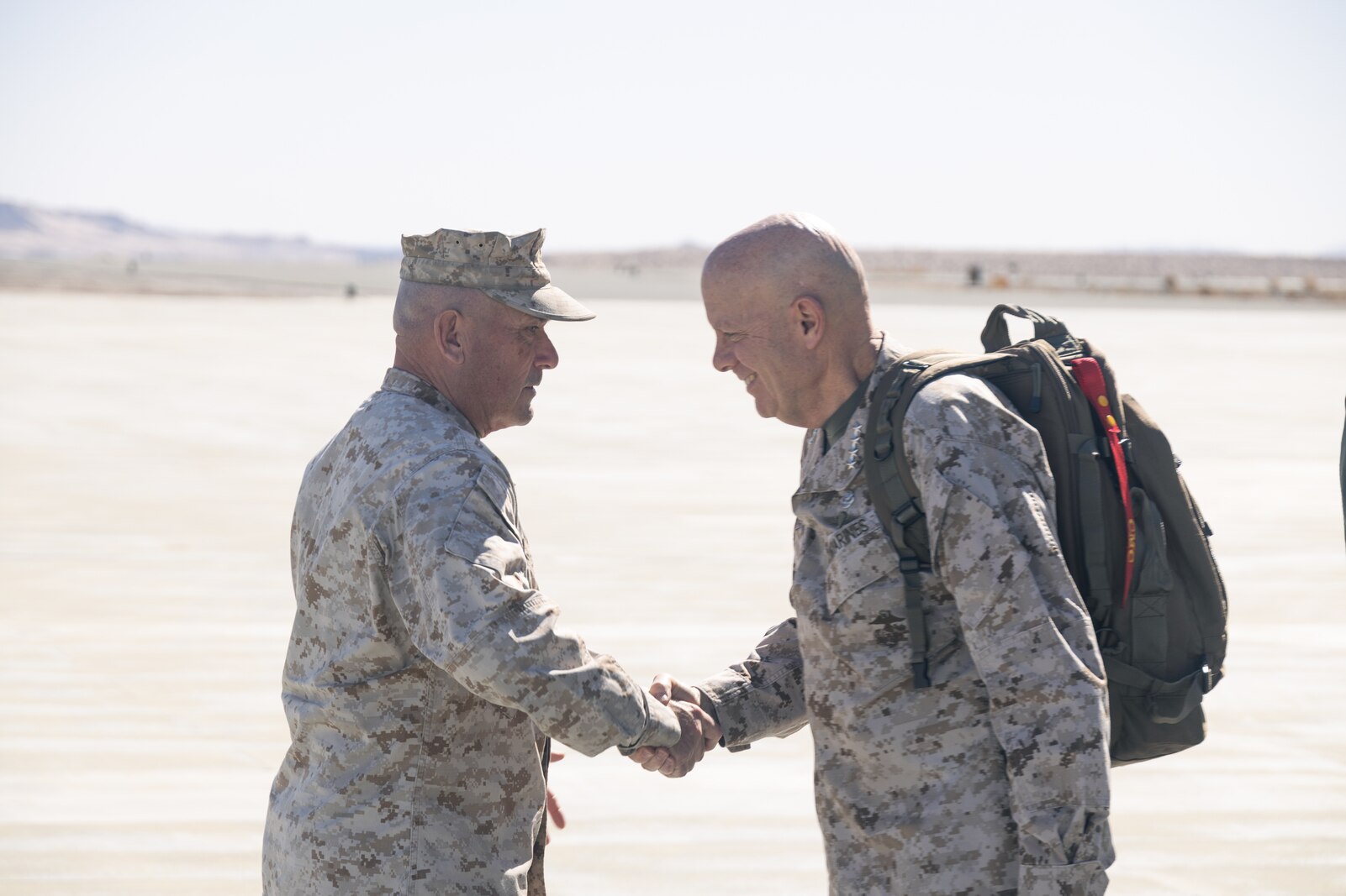 U.S. Marine Corps Maj. Gen. Austin T. Renforth, left, Marine Air Ground Task Force Training Command (MAGTFTC), Marine Corps Air Ground Combat Center (MCAGCC) Commanding General, greets Gen. David H. Berger, Commandant of the Marine Corps