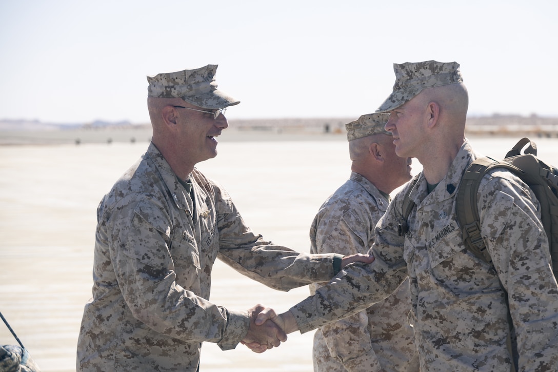 U.S. Marine Corps Col. David A. Suggs, left, Marine Air Ground Task Force Training Command (MAGTFTC), Marine Corps Air Ground Combat Center (MCAGCC) Chief of Staff, greets Sgt. Maj. Troy E. Black, Sergeant Major of the Marine Corps at MCAGCC, Twentynine Palms, California, Feb. 21, 2023. Gen. David H. Berger, Commandant of the Marine Corps and Black visited MCAGCC to observe the implementation of distributed operations in a simulated littoral environment during Service Level Training Exercise 2-23. (U.S. Marine Corps photo by Cpl. Andrew Bray)