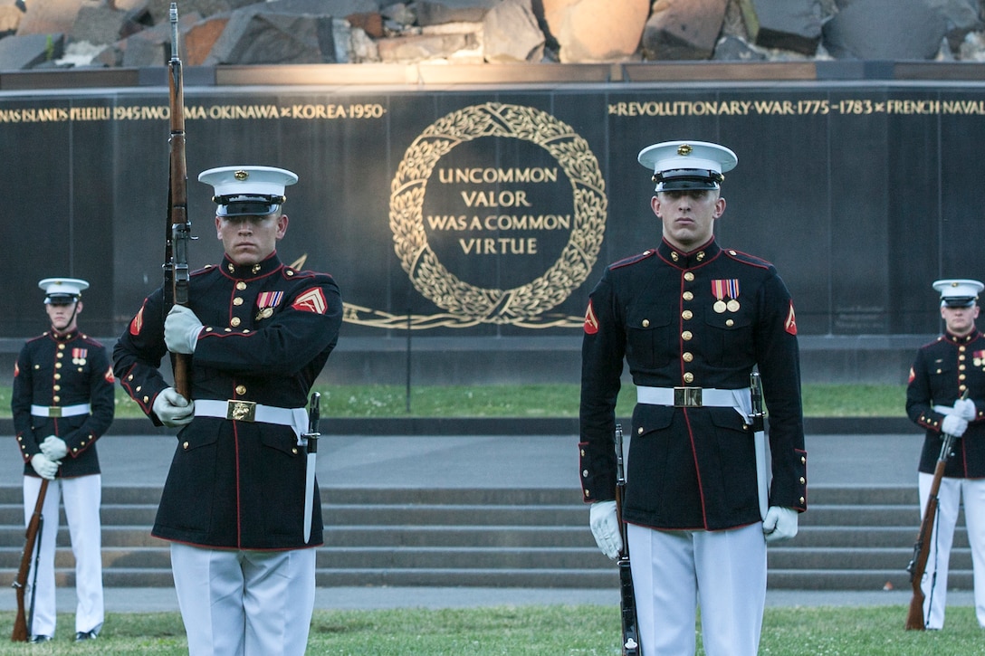 The U.S. Marine Corps Silent Drill Platoon performs during the sunset parade at the Marine Corps War Memorial, Arlington, Va., June 14, 2016. Sunset parades are held as a means of honoring senior officials, distinguished citizens and supporters of the Marine Corps. (U.S. Marine Corps photo by Cpl. Samantha K. Draughon/Released)