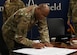 Col. Todd E. Randolph, 316th Wing and installation commander, signs the annual Sexual Assault Awareness and Prevention Month proclamation at Joint Base Andrews, Md., March 15, 2023. The signed proclamation formally recognized April as the month to increase awareness and education regarding SAAP for the base's military and civilian members. (U.S. Air Force photo by Airman 1st Class Austin Pate)