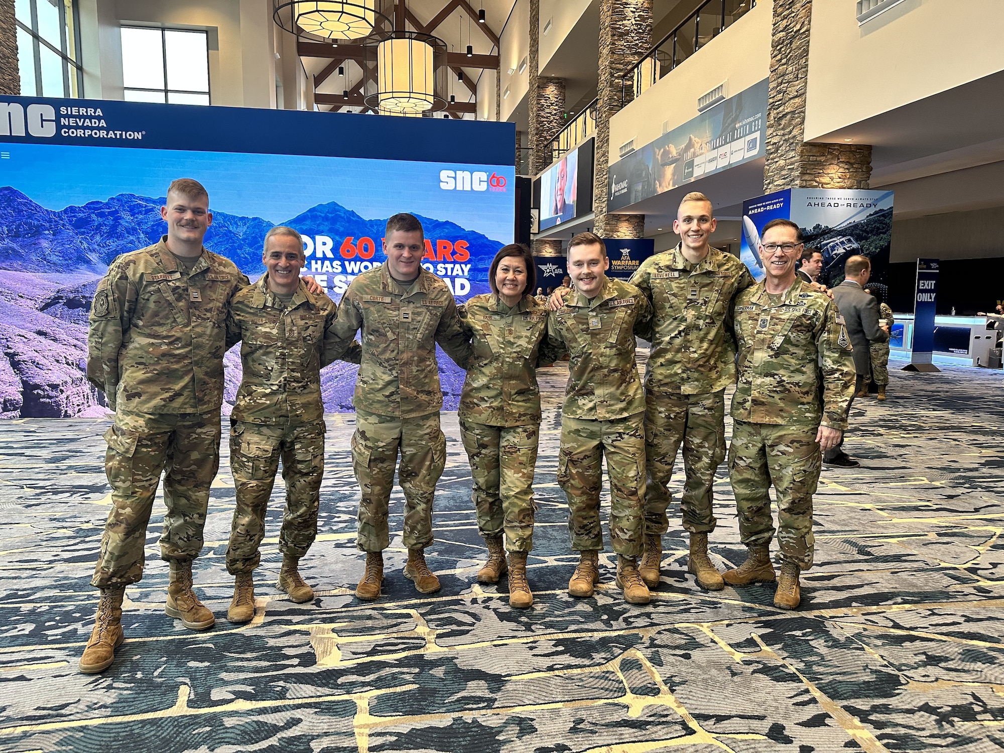 Cadets from Air Force ROTC Detachment 780 at South Dakota State University pose with Chief Master Sgt. of the Air Force JoAnne Bass (center) at the Air and Space Forces Association Air Warfare Symposium in Aurora, Colorado, March 8, 2023. The cadets were given the opportunity to talk with senior Air Force officers and enlisted leaders.