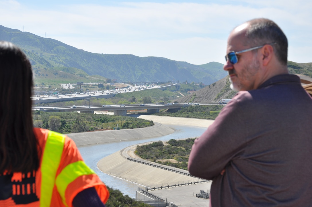 Kirsten Bedolla, deputy lead engineer for the Prado Dam spillway project describes the U.S. Army Corps of Engineers modification plan for Travis Tutka, acting chief of the Dam and Levee Safety Branch at the Corps’ Headquarters, March 9, near Corona, California. The spillway is the last feature of the project to be constructed, which includes raising the spillway by 20 feet.