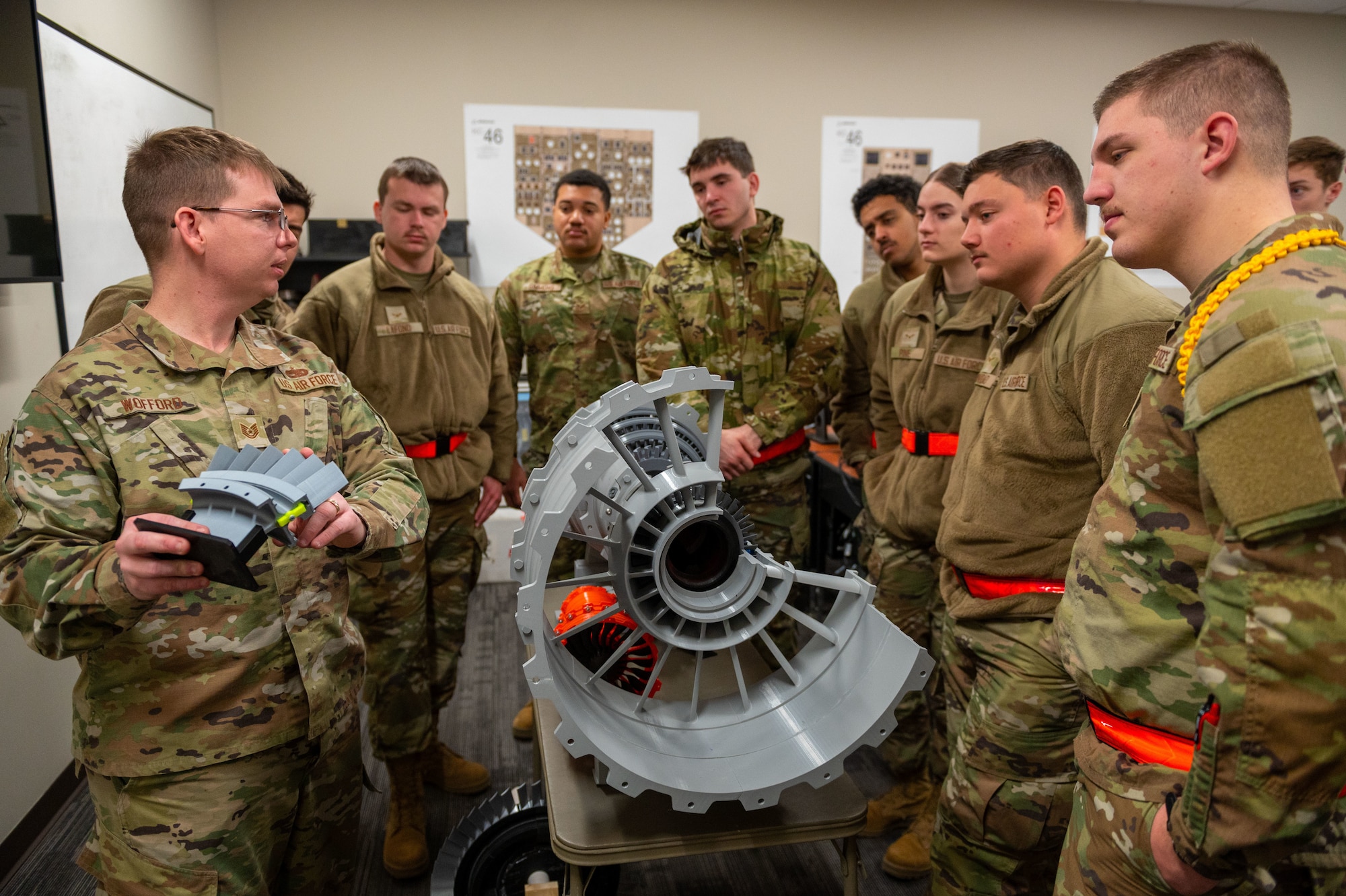 Tech. Sgt. Shane Wofford, 373rd Training Squadron Detachment 8 propulsion instructor, teaches technical school Airmen on how to identify the number one fan blade of a turbofan engine Feb. 24, 2023, at McConnell Air Force Base, Kansas. Wofford utilized a 3D printed model of a turbofan engine that he created for the dsetachment. (U.S. Air Force photo by Airman 1st Class Brenden Beezley)