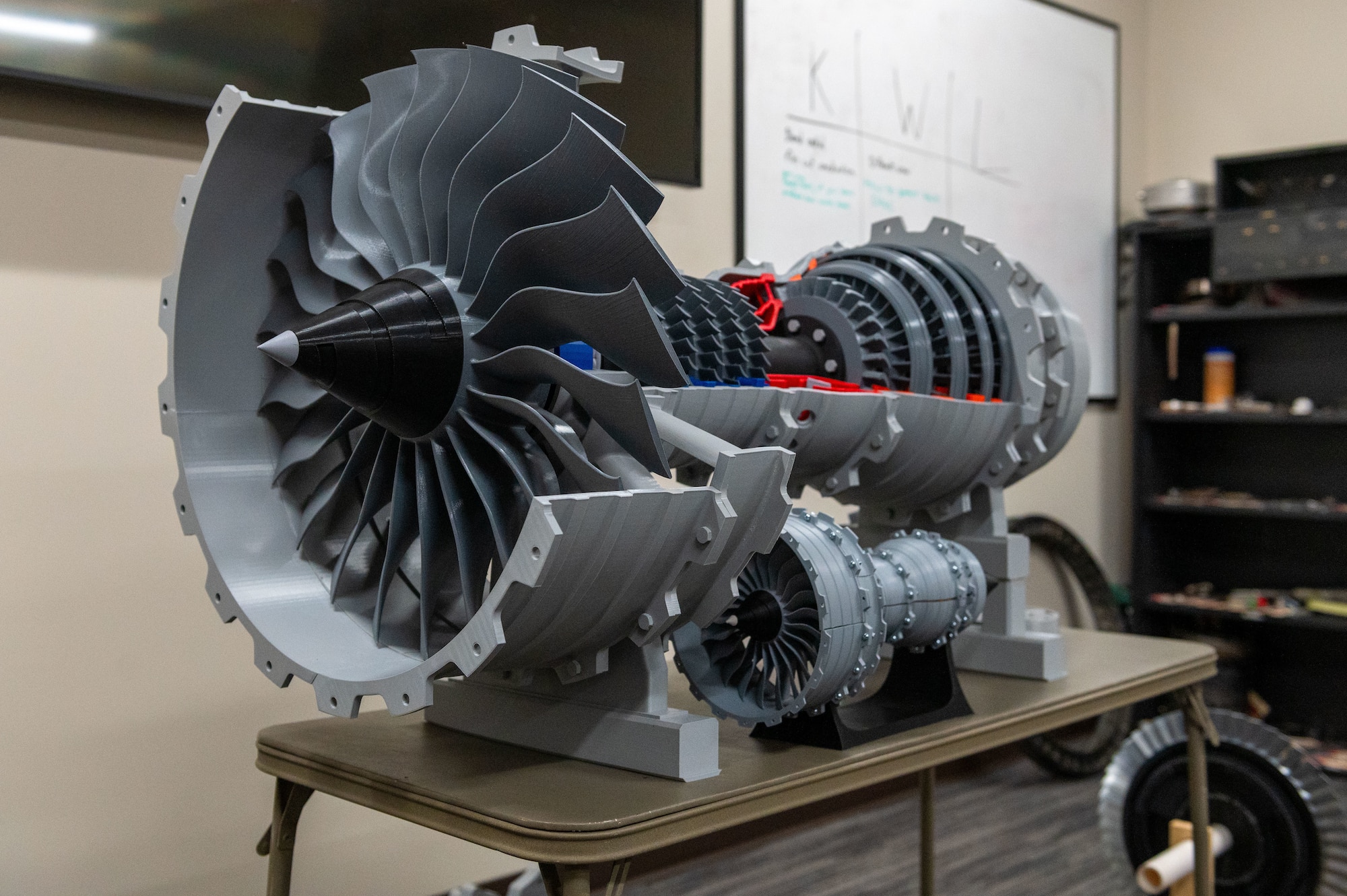 A 3D printed model of a turbofan engine is displayed on a table March 2, 2023, at McConnell Air Force Base, Kansas. The model was created by Tech. Sgt. Shane Wofford, 373rd Training Squadron Detachment 8 propulsion instructor, to bridge a gap he saw in the training curriculum. (U.S. Air Force photo by Airman 1st Class Brenden Beezley)