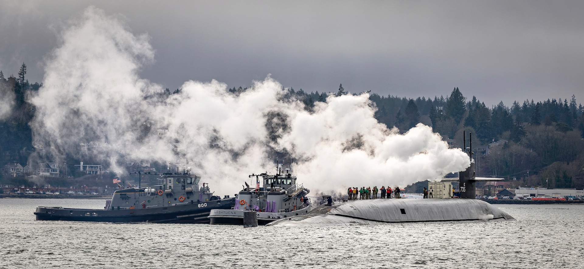 USS Pennsylvania (SSBN 735) is escorted to Pier 5 at Puget Sound Naval Shipyard & Intermediate Maintenance Facility in Bremerton, Washington, March 1, 2023, where it will begin an Extended Refit Period availability. Temporary system installation work began immediately upon arrival. Production work, including regularly scheduled preventative maintenance requirements, modernization and structural repairs, are scheduled to begin later next month. (U.S. Navy photo by Scott Hansen)
