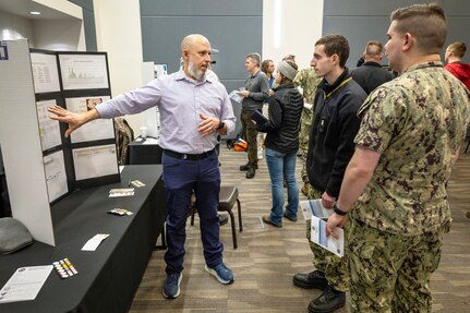 Jon Hall, assistant chief test engineer work control, Code 246, Puget Sound Naval Shipyard & Intermediate Maintenance Facility Non-Nuclear Test House, explains the improved work authorization process to Sailors assigned to USS Pennsylvania (SSBN 735) during an Integrated Project Team Development Expo March 2, 2023, at the Kitsap Conference Center in downtown Bremerton, Washington. (U.S. Navy photo by Scott Hansen)