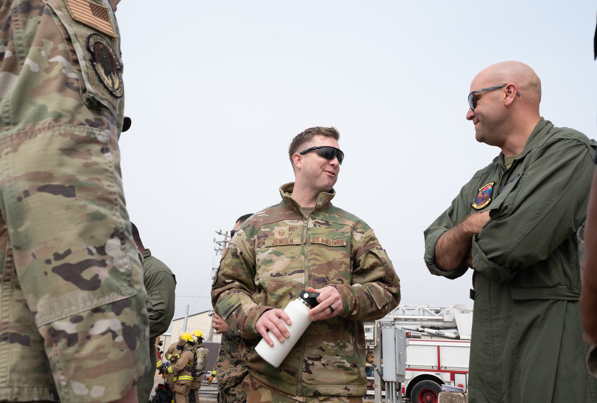 U.S. Air Force Master Sgt. Jarrod Jensen, 8th Civil Engineer Squadron deputy fire chief, speaks with U.S. Marine Corps Chief Warrant Officer 3 Brian Krantz, Marine Wing Support Squadron 172 expeditionary firefighting and rescue officer in charge, at Kunsan Air Base, Republic of Korea, Mar. 9, 2023. Based out of Camp Foster, Okinawa, Japan, the MWSS 172 brought approximately 50 personnel to the Wolf Pack to train on responding to controlled, structural fires. (U.S. Air Force photo by Staff Sgt. Sadie Colbert)