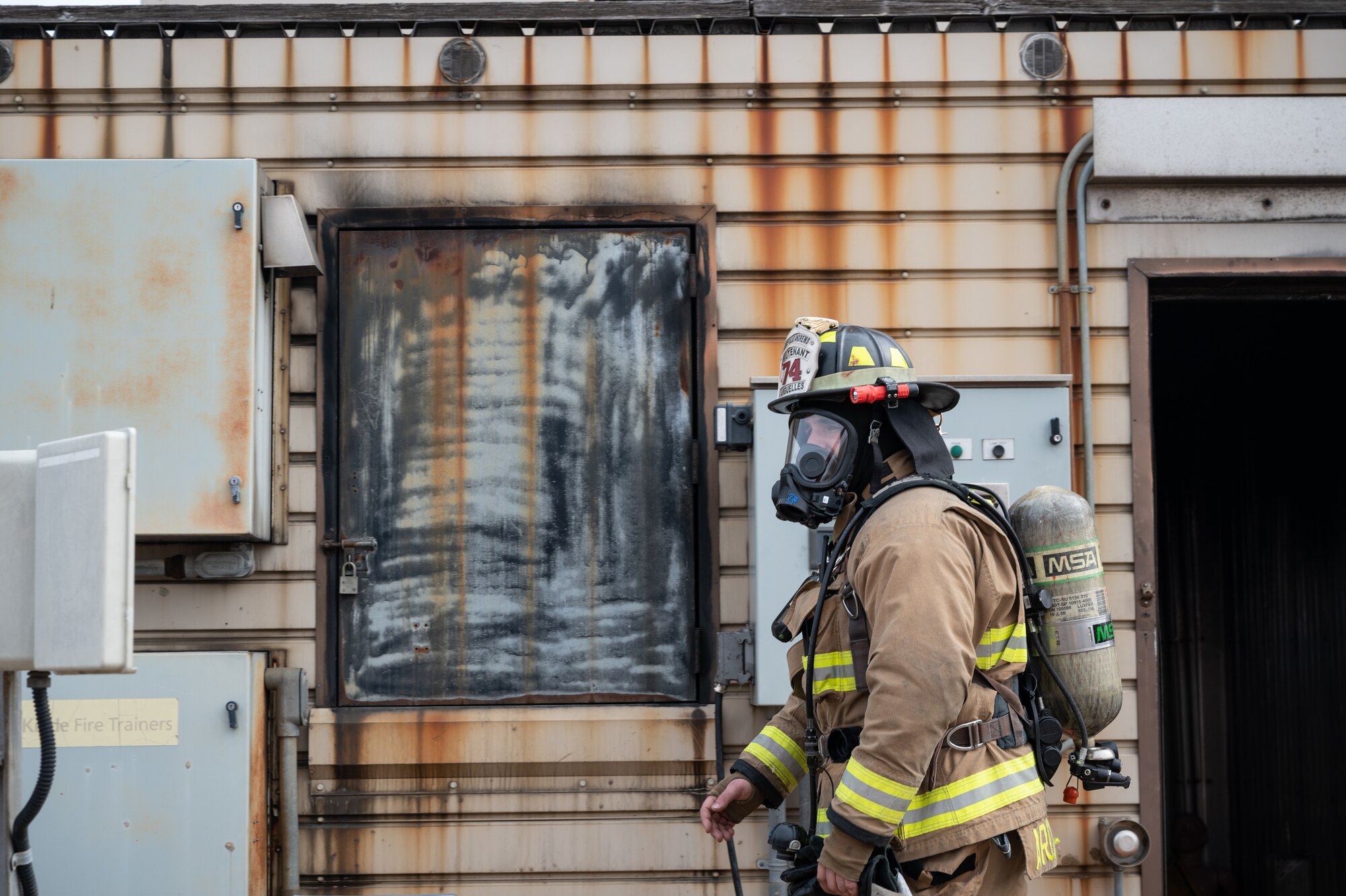 U.S. Air Force Staff Sgt. Bobby Arguelles, 8th Civil Engineer Squadron firefighter, walks away from a training building at Kunsan Air Base, Republic of Korea, Mar. 9, 2023. Wolf Pack
firefighters trained alongside U.S. Marine Corps firefighters out of Camp Foster, Okinawa, Japan, who focus more on responding to aircraft and airport fires than structural fires. (U.S. Air Force photo by Staff Sgt. Sadie Colbert)