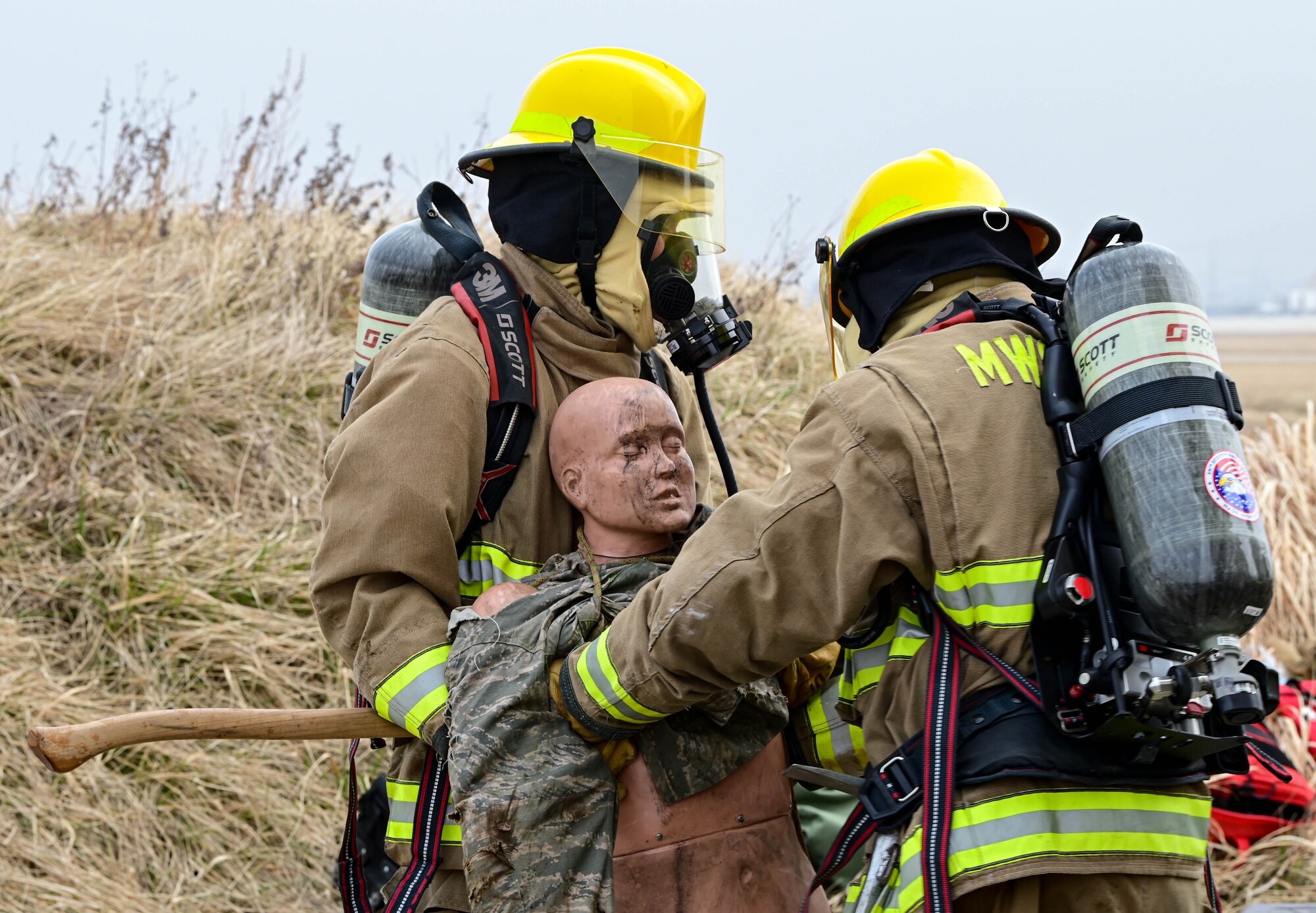 U.S. Marine Corps Lance Cpl. James Ebken (left), Marine Wing Support Squadron 172 firefighter, helps carry a simulated victim with another Marine during a joint training event at Kunsan Air Base, Republic of Korea, Mar. 9, 2023. The joint training included controlled, structural burn training where Airmen and Marines split into teams and rotated through several times to enhance their performance. (U.S. Air Force photo by Senior Airman Shannon Braaten)